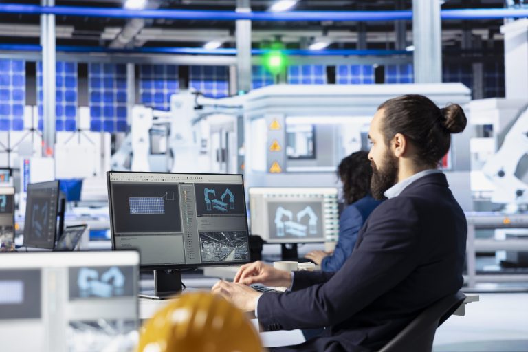 Specialist in solar panel manufacturing facility analyzing production metrics